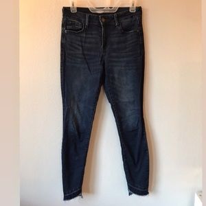 Dark indigo jeans with distressed hem